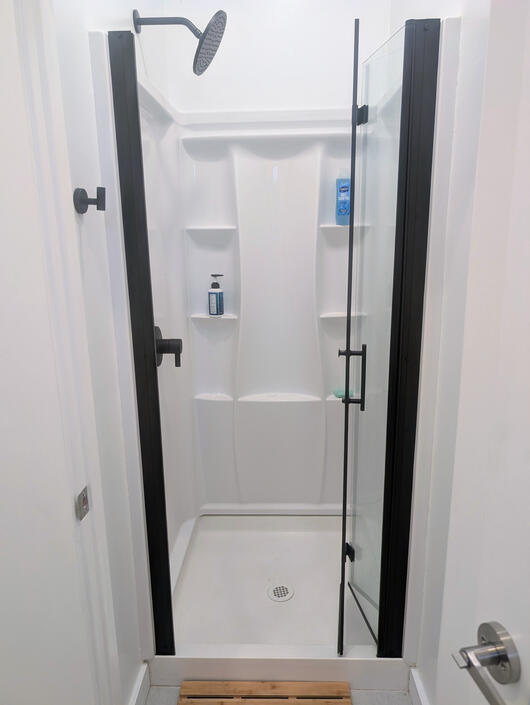 Mini shower rooms with glass doors and mirror