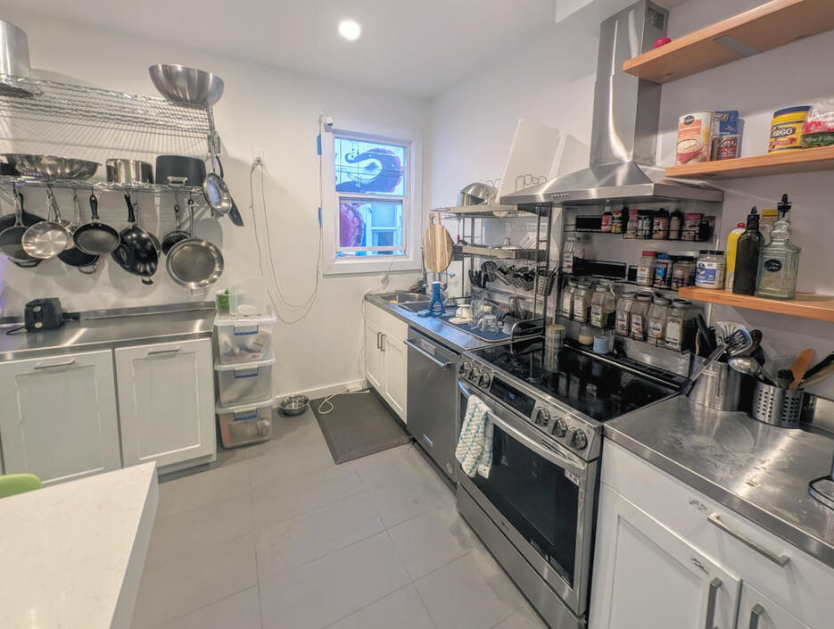 Well stocked stainless steel kitchen including induction stove, 3 ovens, 2 dishwashers