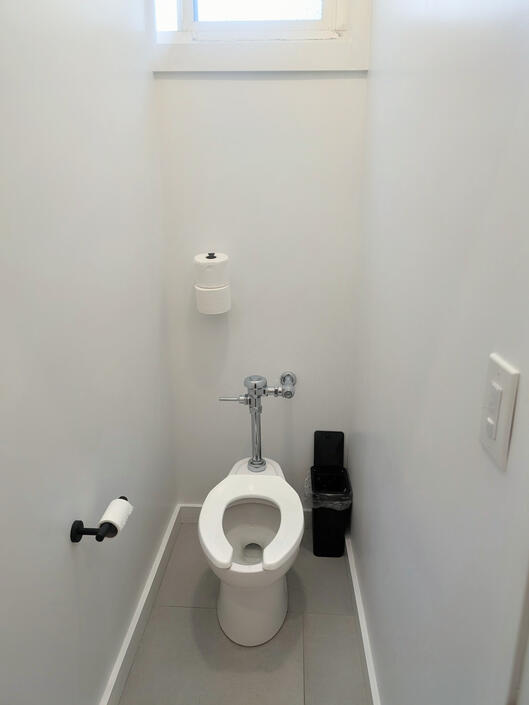One of many toilet stalls with fully enclosed doors